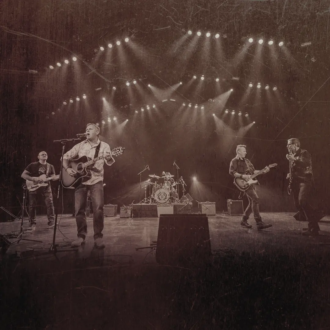 Renegade on a big stage under a full light rig