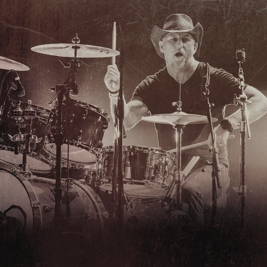 Drummer in a straw cowboy hat mid-fill