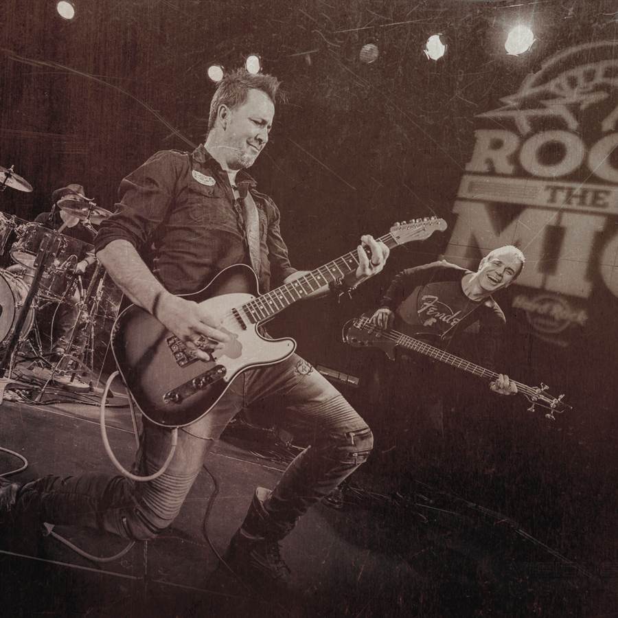 Renegade guitarist kneeling on stage at the Hard Rock Casino Rock the Mic competition